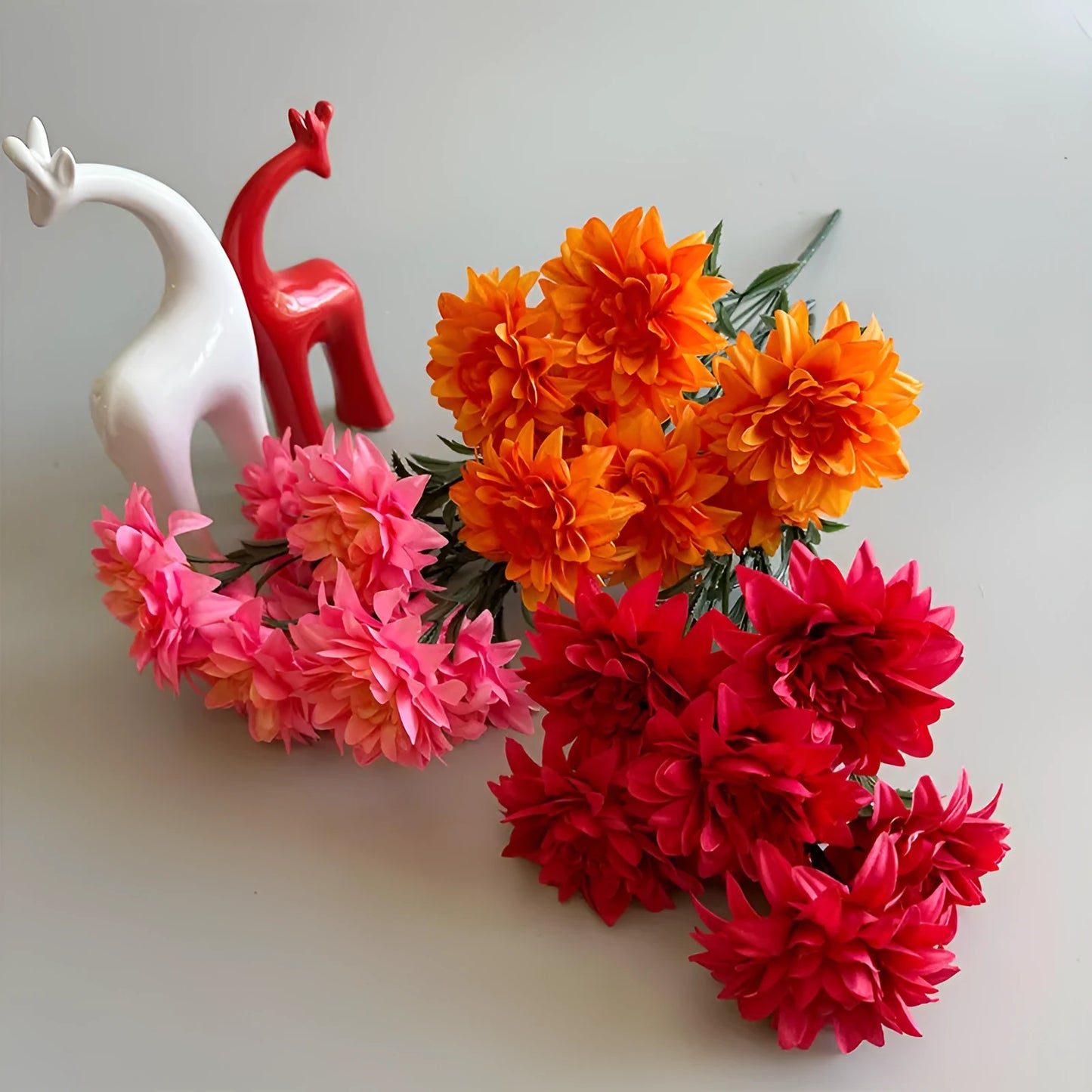 Desktop fan-shaped display holding artificial silk flowers in rose and peony varieties with colourful petals