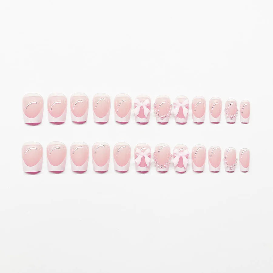 Fashion short white French cute bow manicure set with 24 nail art pieces including tulip, bow, starry sky, leopard print, and XINGX designs.