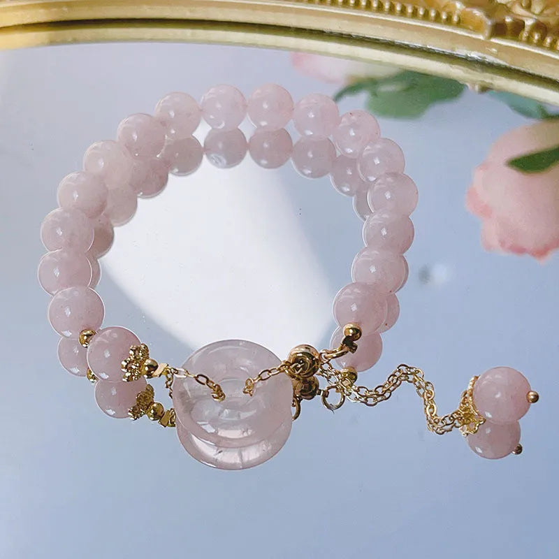 Pink crystal women's bracelet with peace buckle closure on adjustable band