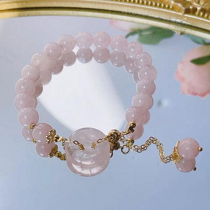 Pink crystal women's bracelet with peace buckle closure on adjustable band