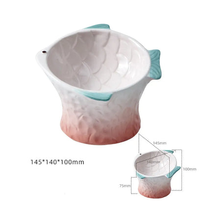Set of four blue fish-shaped ceramic cat bowls with a tilted design on a wooden floor.