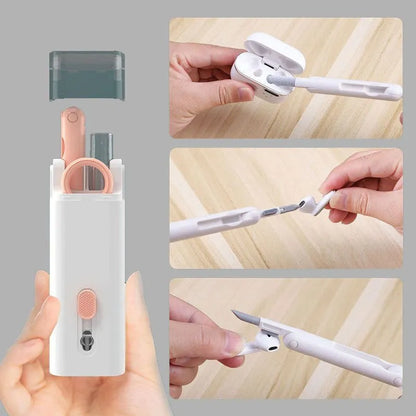 White electronics cleaning kit with a cleaning pen, spray bottle, brush, and keycap puller on a table