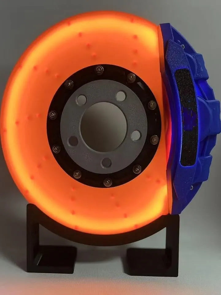 Brake disc design LED night light with caliper details in blue, red, or yellow colour options on desktop