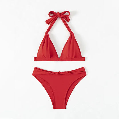 Red women's lace-up halterneck bikini top and shorts set on a mannequin