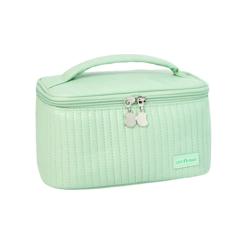 Open-top pastel pink PU leather makeup bag with a flat base, showing interior space.