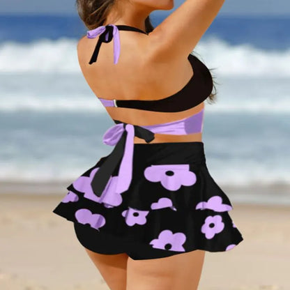 Purple women's bikini and high-waisted skirt swimsuit set with lace-up back detail.