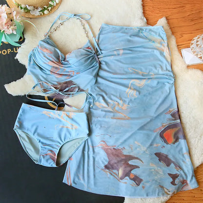 Women's blue printed triangle bikini set with skirt, showing steel support push-up top.