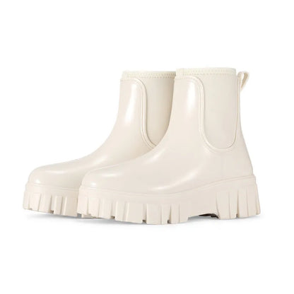 Women's creamy-white low tube PVC rain boots with a flat heel and thickening sole, shown from the side.