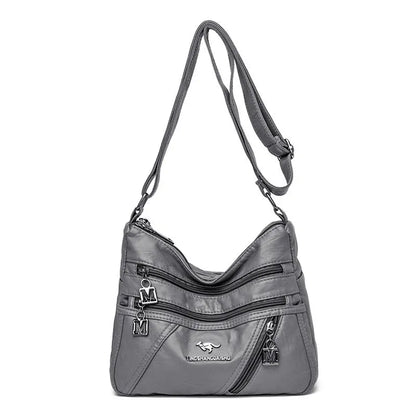 Middle-aged women's double layer PU shoulder bag with large capacity, welt pocket, and soft build in red, purple, dark blue, black, bronze, gray, or tan.
