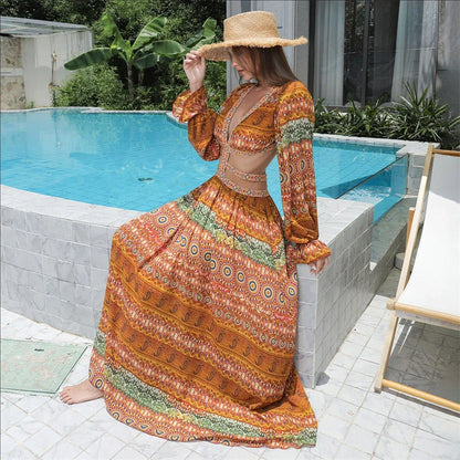 Elegant floral print dress with long sleeves and empire waistline in vibrant orange color