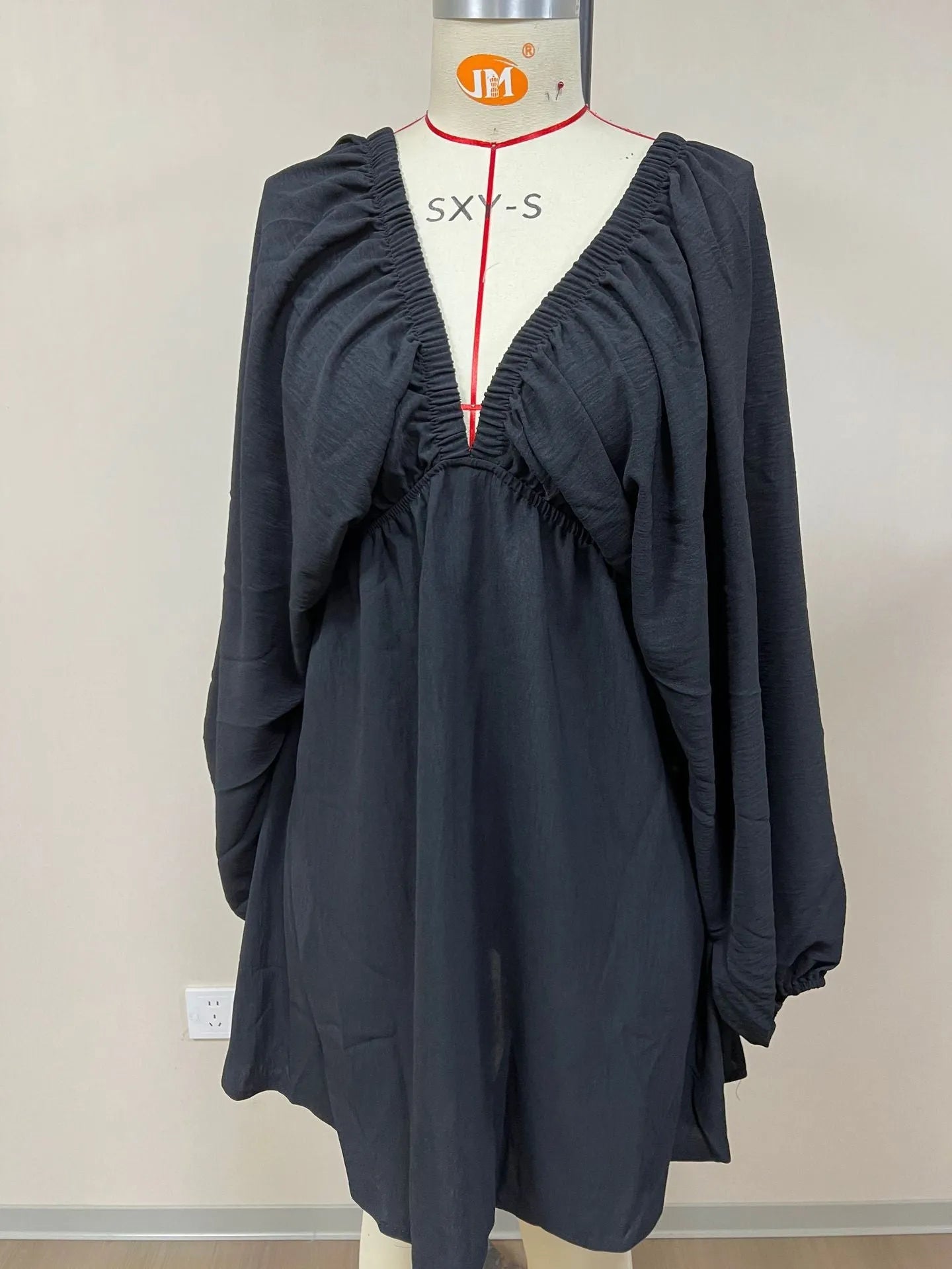 Women's apricot V-neck dress with long puff sleeves and a flounced swing skirt.