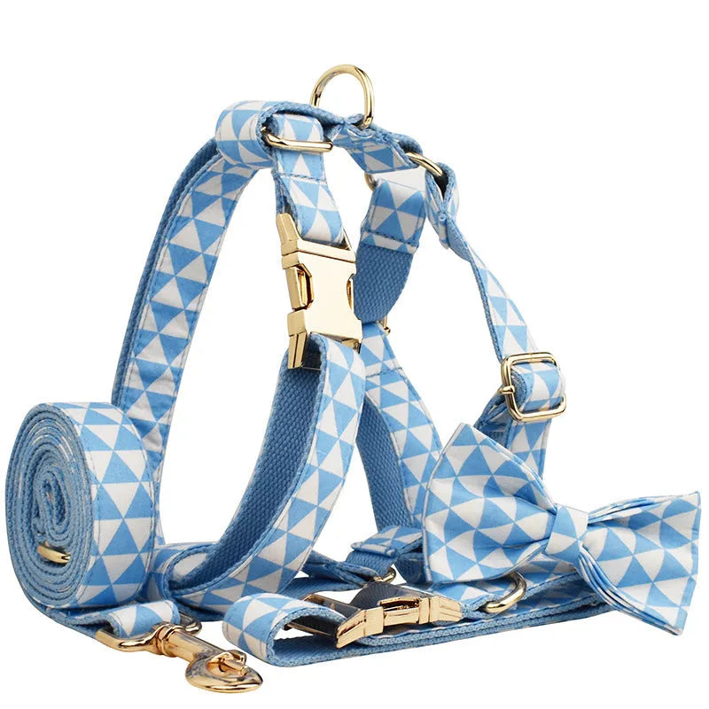 Blue cloth dog accessory set with collar, leash, bow, and vest shown together