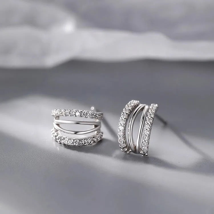 Pair of modern geometric stud earrings with a silver electroplated finish on a 925 silver post.