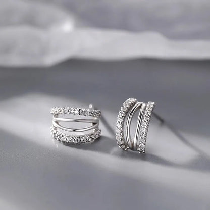 Pair of modern geometric stud earrings with a silver electroplated finish on a 925 silver post.
