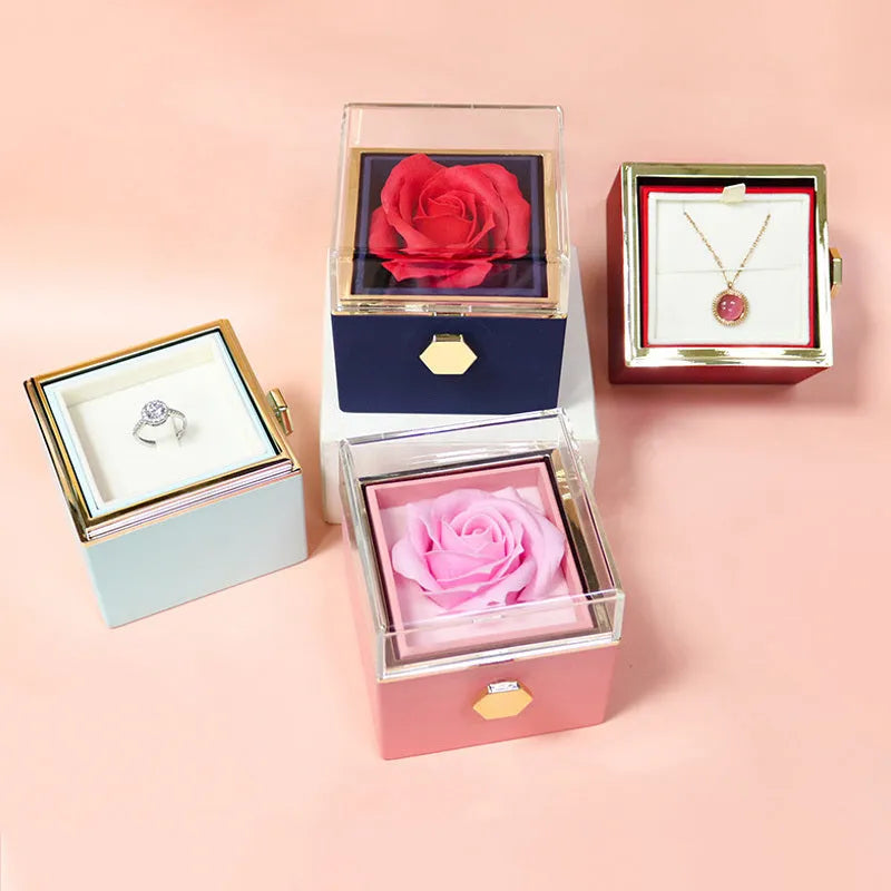 Rotating rose jewellery gift box with a preserved red rose under a clear acrylic dome, showing the interior rotating drawer.