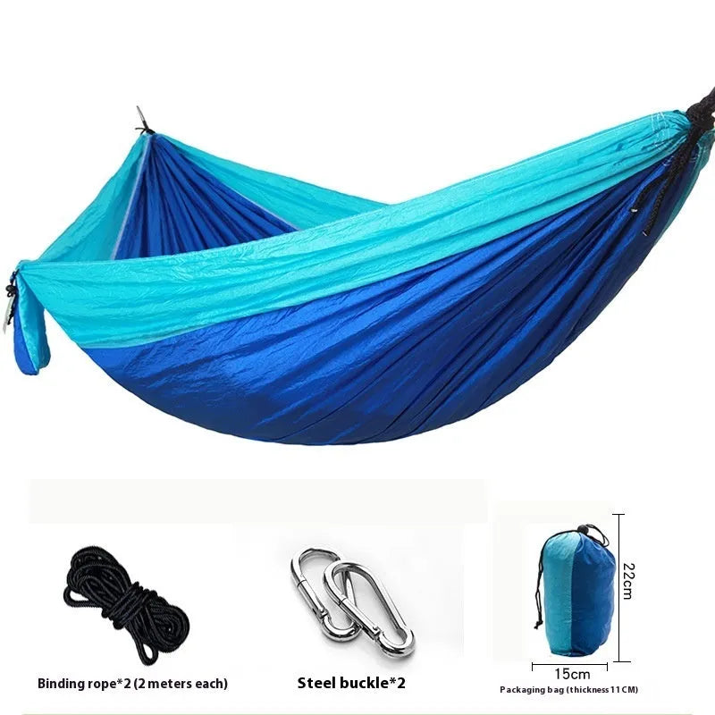 Parachute cloth double camping hammock in chosen colour, with black buckles and round ropes on a tree.