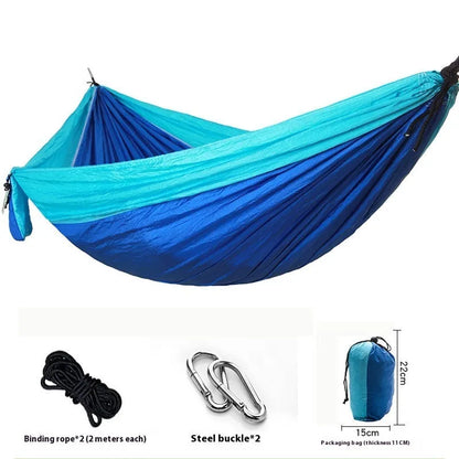 Parachute cloth double camping hammock in chosen colour, with black buckles and round ropes on a tree.