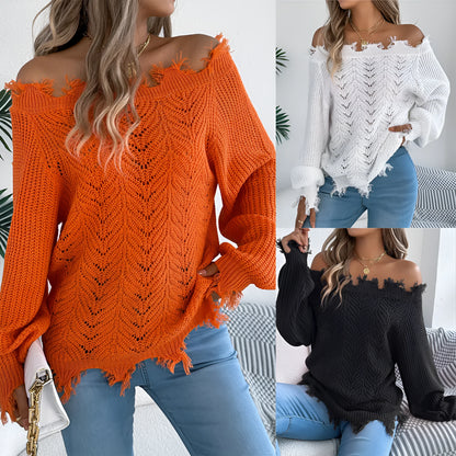 Women's black off-the-shoulder pullover sweater with hollow-out long sleeves on a hanger.