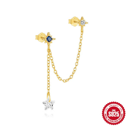 Close-up of a sterling silver double piercing chain stud earring with inlaid zircon stone in a golden colour.