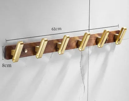 Black walnut wood clothes hooks with brass-finished aluminium frame in a 4-hook wall-mounted style