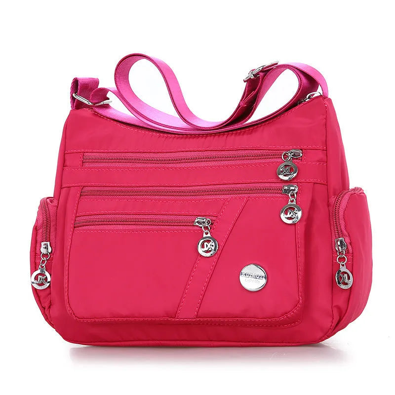 Women's nylon shoulder bag with multi-pocket design, zip opening and detachable handle in red, purple, black or army green