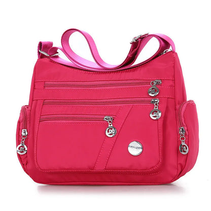 Women's nylon shoulder bag with multi-pocket design, zip opening and detachable handle in red, purple, black or army green