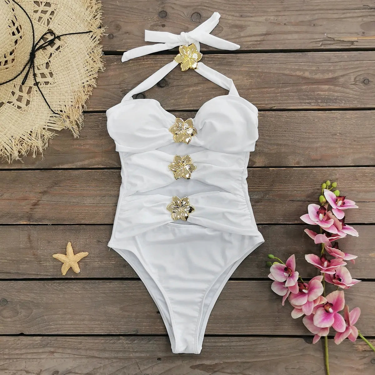 Women's solid colour one-piece swimsuit with attached short skirt in black, showing high-waisted fit and hollow-out tube top design.
