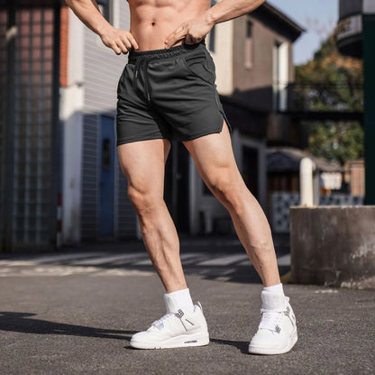 Men's black polyester sports casual shorts with a straight-leg cut on a grey background.