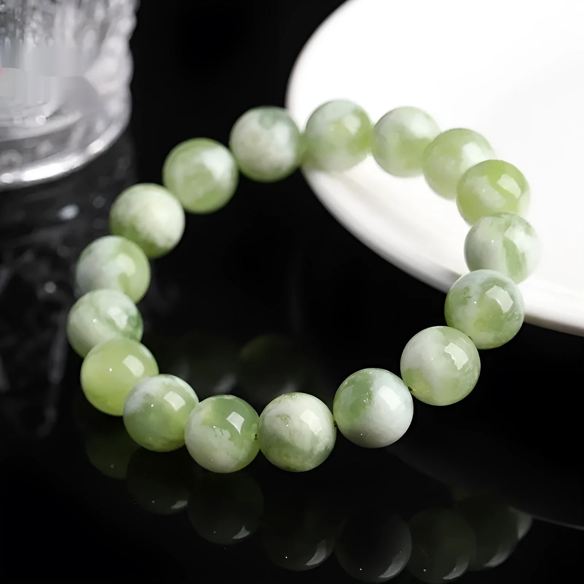 Green milk-in-water Xiuyan jade bracelet with polished geometric beads.