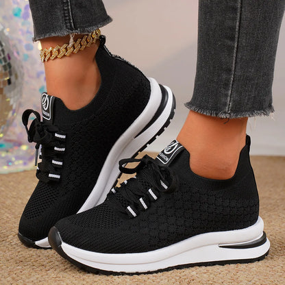Women's flat lace-up mesh sneakers in black and white colours with round toe