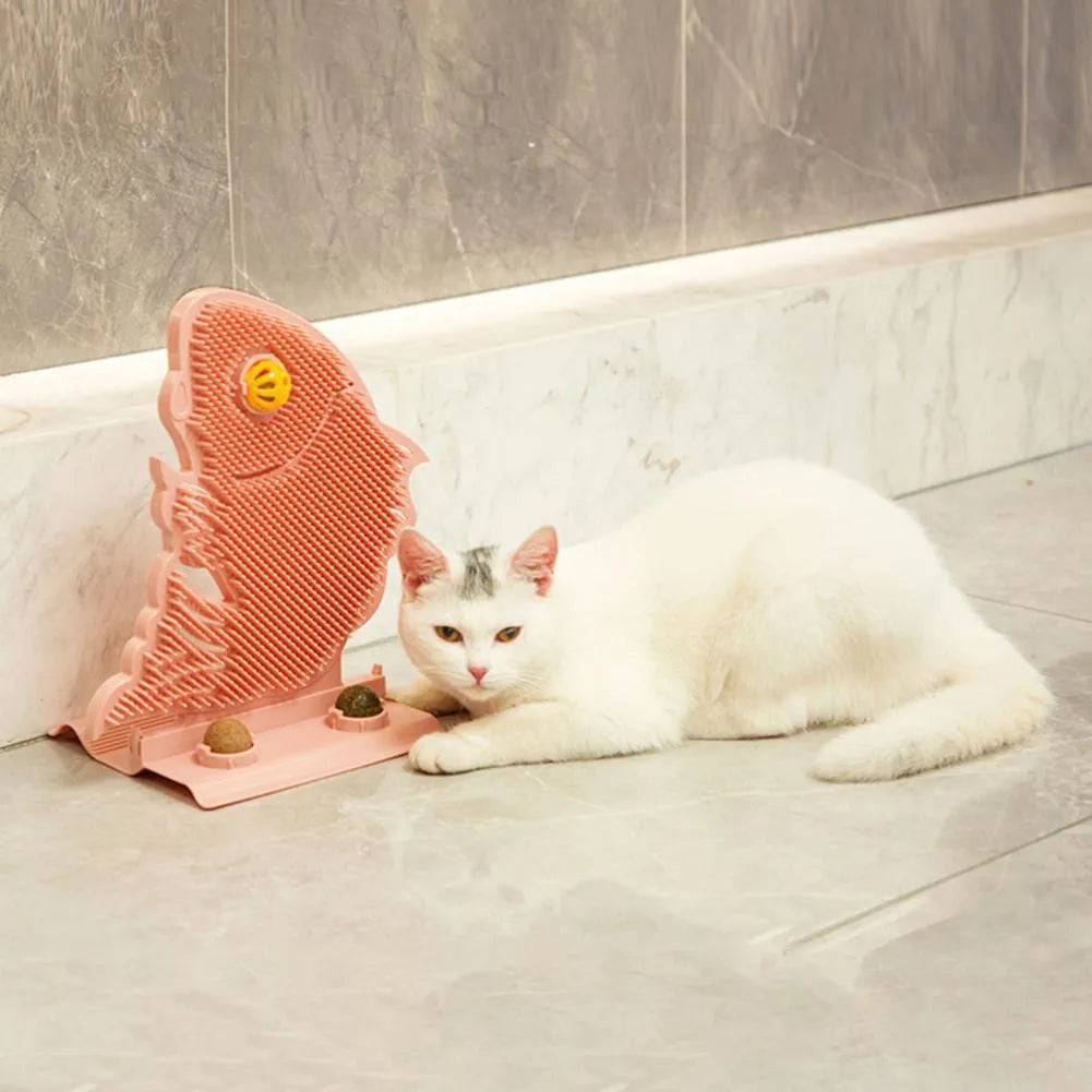 Blue plastic fish-shaped cat wall scratcher with grooming brush, catnip balls, and bell