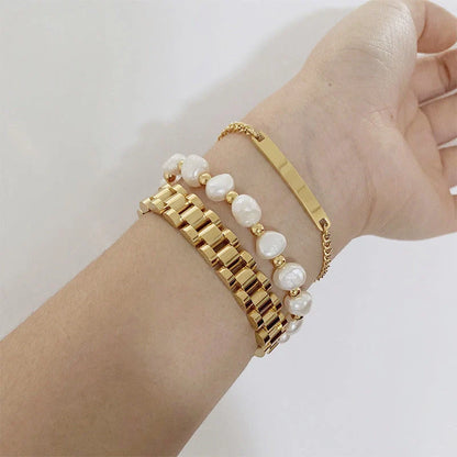 Elegant titanium steel bracelet watch with adjustable, geometric design in gold and stainless steel colours