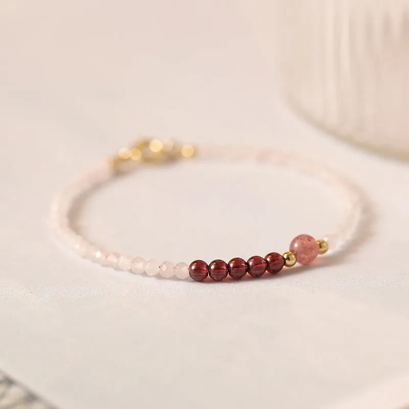 Handmade pink crystal bracelet with strawberry quartz charm showing 2mm beads