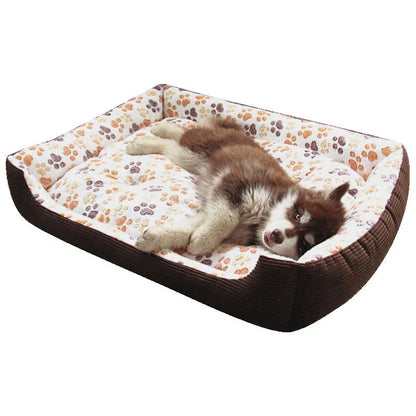 Beige plush pet bed for small dogs with a removable cover and non-slip base, shown in a home setting.