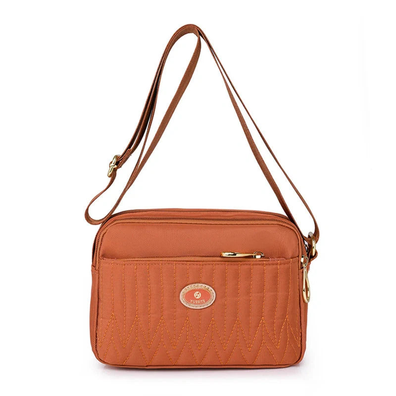 Compact nylon messenger bag for women in various colours with adjustable strap