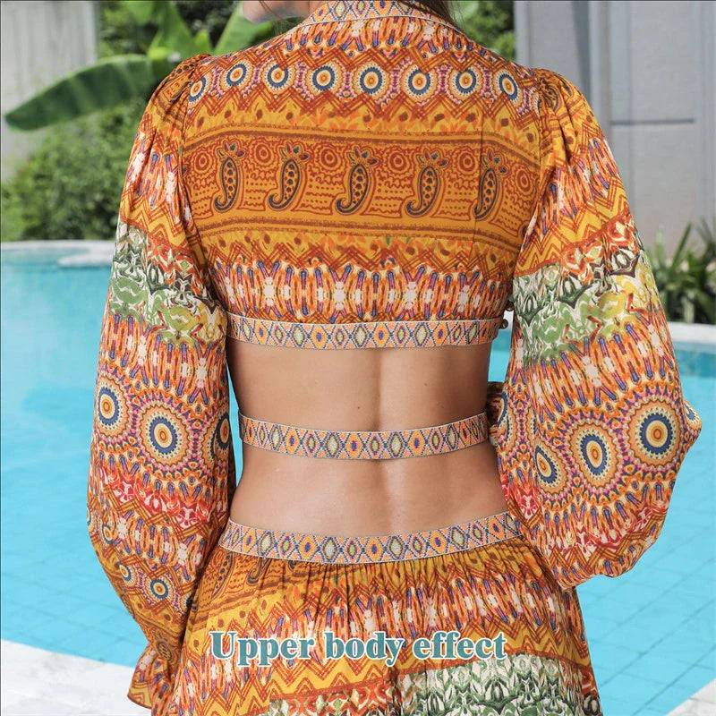 Elegant floral print dress with long sleeves and empire waistline in vibrant orange color
