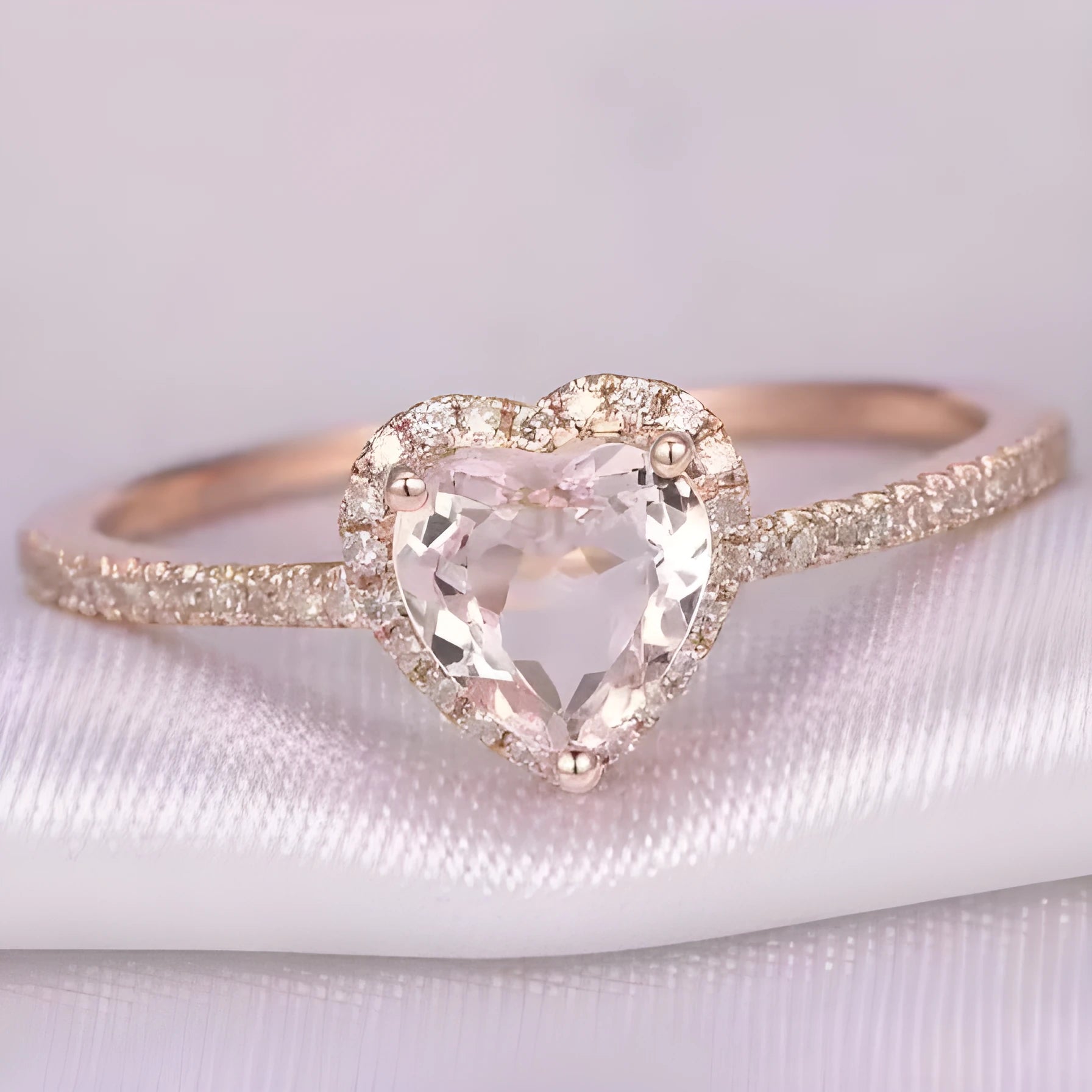 Women's heart-shaped crystal ring in rose gold or silver tone on white copper.
