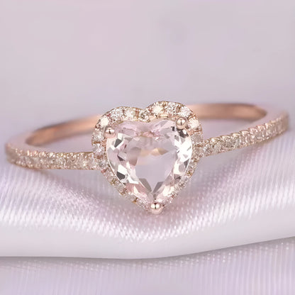 Women's heart-shaped crystal ring in rose gold or silver tone on white copper.