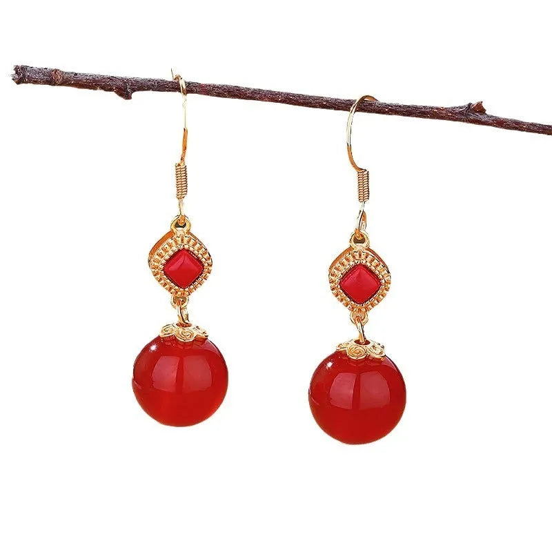 Geometric silver-toned earrings with round red agate beads and small inlaid jasper stone accents.