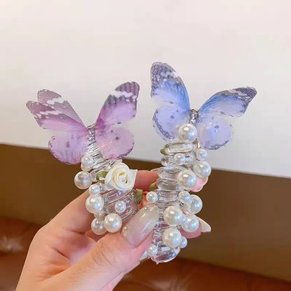 Colourful butterfly and pearl elastic hair band for children on a white background.