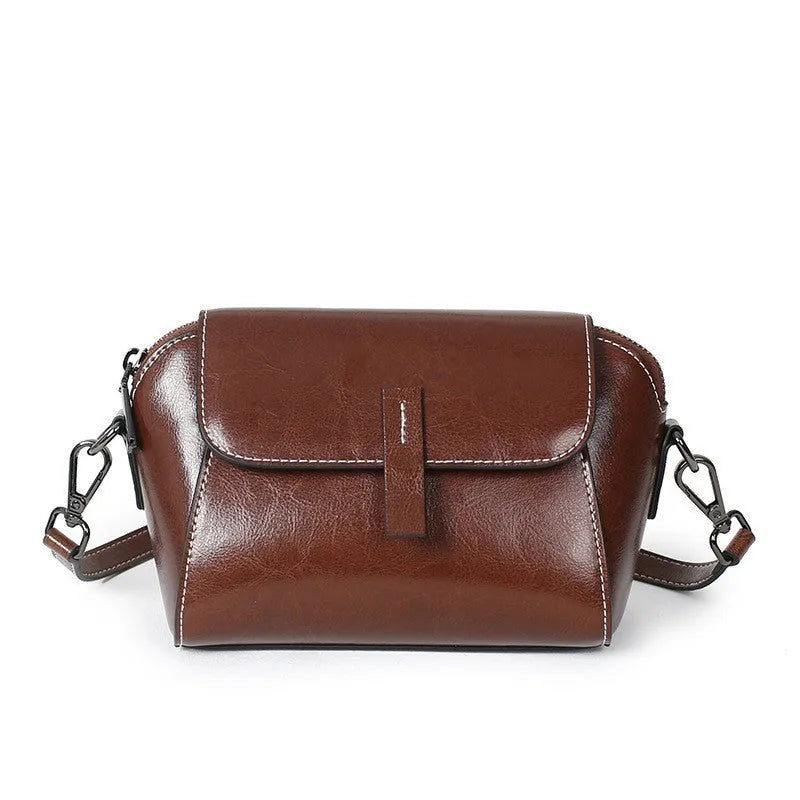 Women's brown oil wax cowhide leather messenger bag with crossbody strap and organised interior pockets