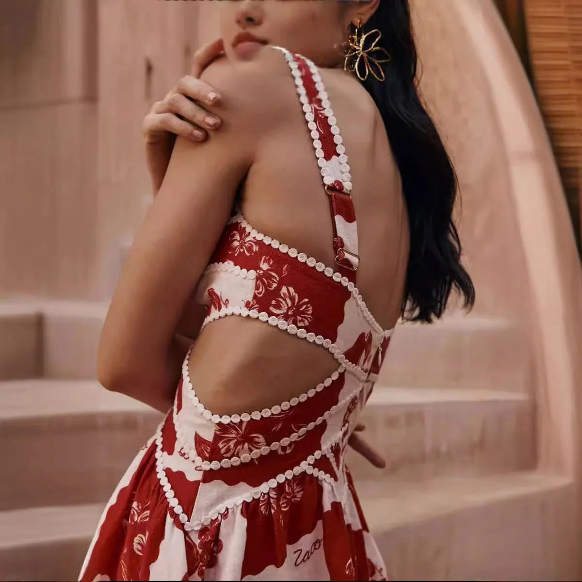 A beautiful red flower-patterned lace slip dress with a v-neck and waist cutout, perfect for summer fashion