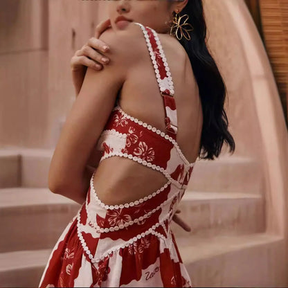 A beautiful red flower-patterned lace slip dress with a v-neck and waist cutout, perfect for summer fashion