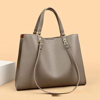 Women's messenger tote bag in horizontal square shape with crossbody strap and internal compartments
