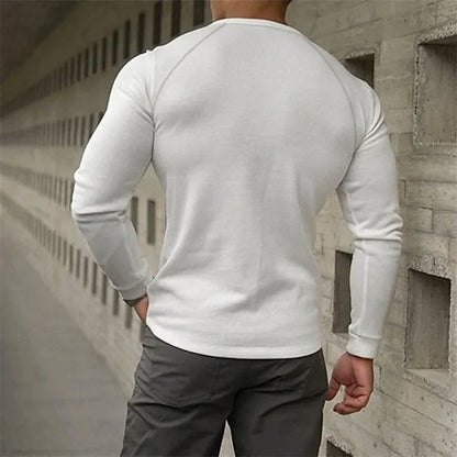 Men's white long-sleeved t-shirt with a Henry collar laying flat