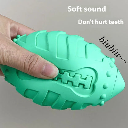 A light green thickened rubber rugby ball dog chew toy on a plain background.