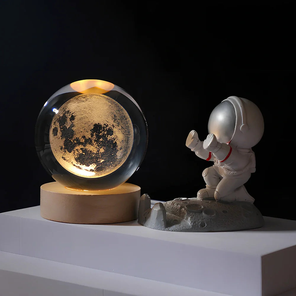 Cosmos Series crystal ball night light with wooden base and astronaut figure, showing Milky Way light pattern