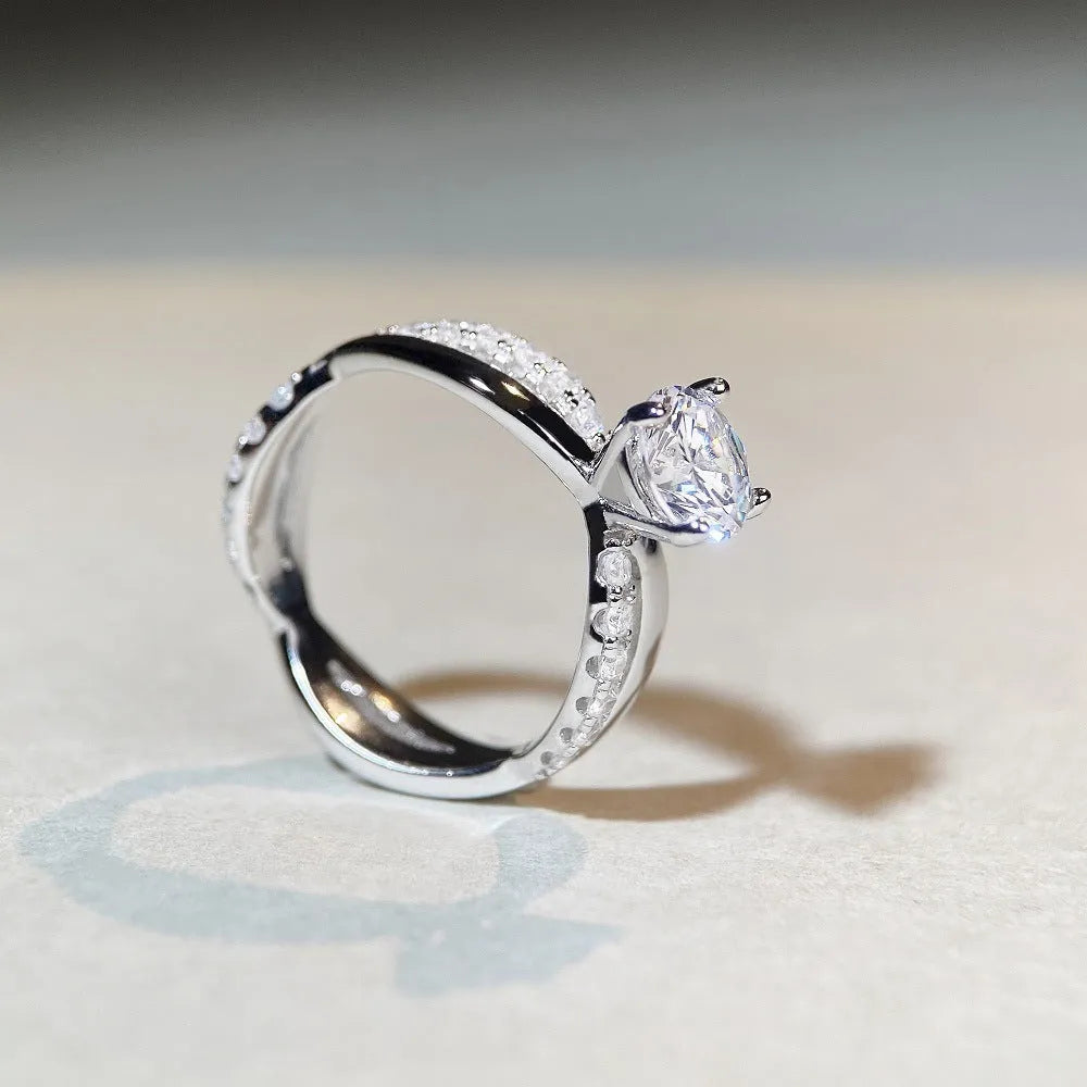 Geometric silver ring with winding twisted arm and 1 karat moissanite stone in four-claw setting