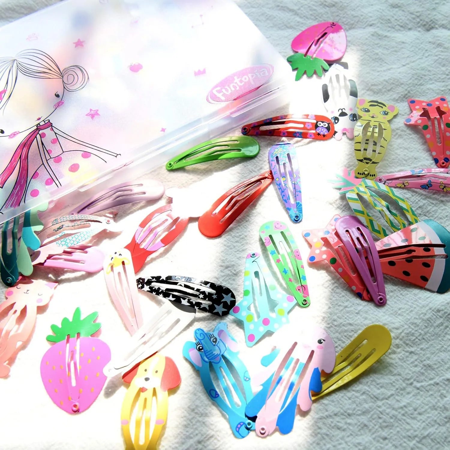 Assortment of 100 hair clips with cartoon designs including animals, fruits, crowns and stars in bright colours