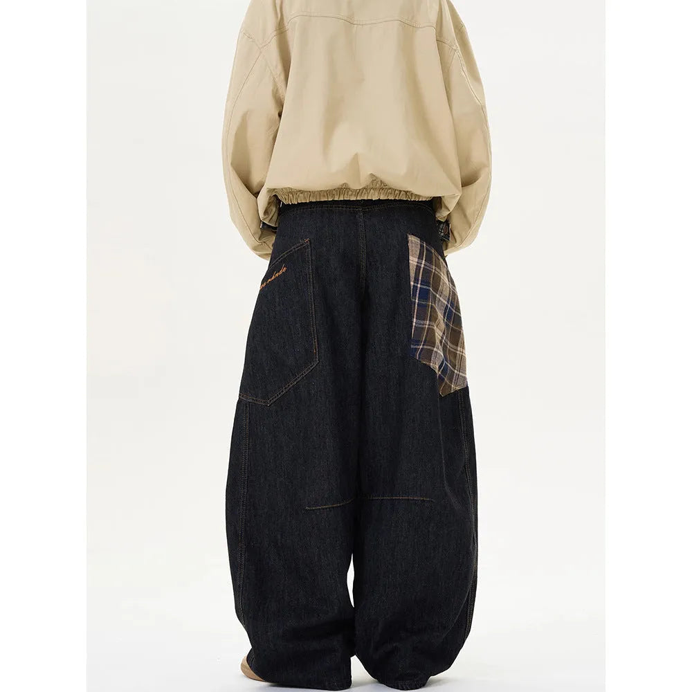Loose straight-leg cotton trousers in a red plaid pattern, laid flat.
